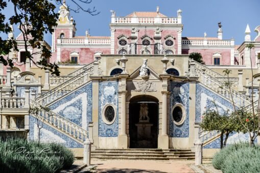 The stunning rococo facade and grand entrance staircase of the historic Palácio Estôi, a luxury wedding venue. Pink Rococo palace facade and grand entrance staircase of Palácio Estôi wedding venue in the Algarve, Portugal.